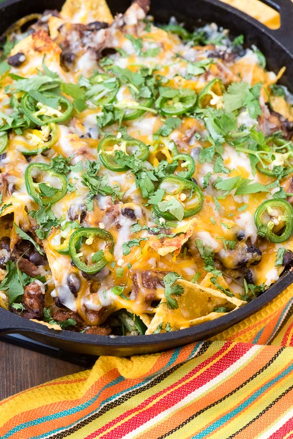 Pot Roast Nachos with two types of melted cheese, sliced jalapenos