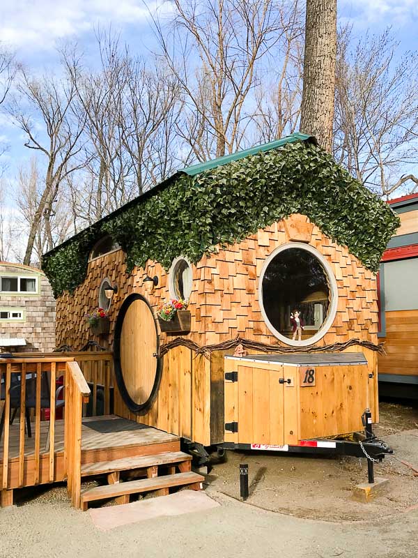 Exterior of the shingled Hobbit House Tiny House at WeeCasa Resort Lyons CO