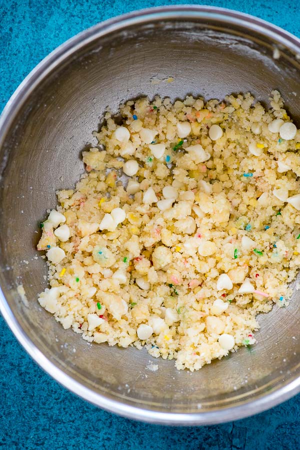 Dough for gluten-free Cake Mix Funfetti Cookies in a silver mixing bowl