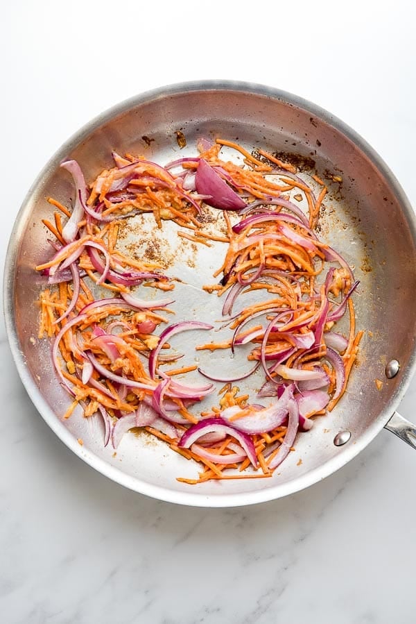 Red onion and carrots in large skillet for Dragon Shrimp Noodles