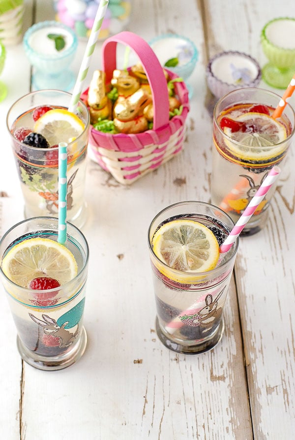 Glasses of Elderflower Gin Fizz cocktails, small basket of foil chocolate bunnies