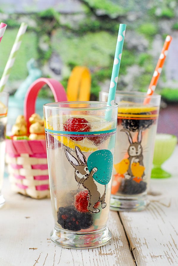 Elderflower Gin Fizz cocktail in a highball Easter glass with frozen berries