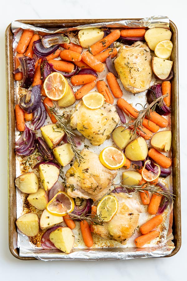 chicken thighs on a sheet pan with vegetables