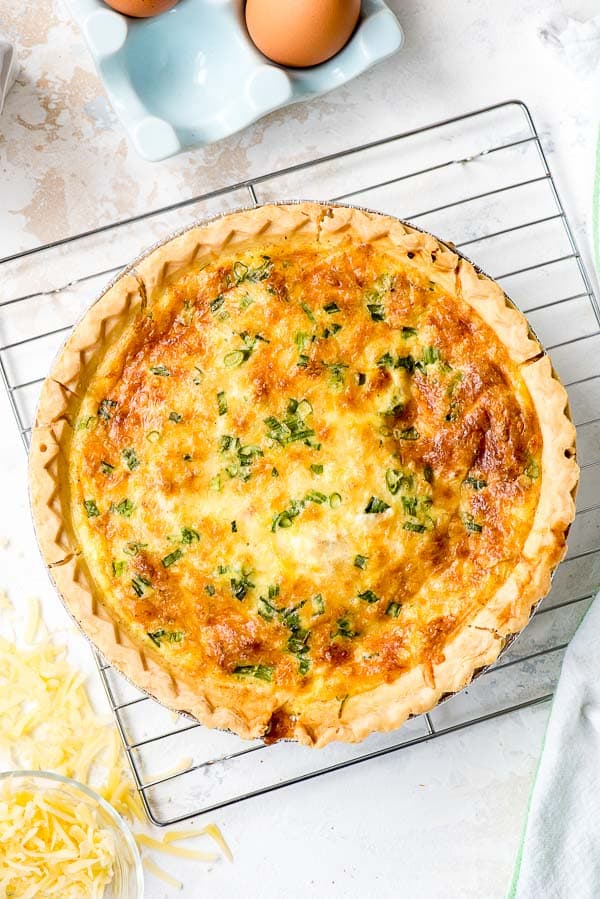 Golden brown Quiche Lorraine on a cooking rack