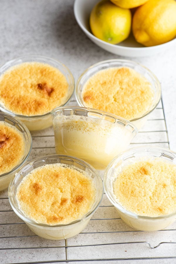 Lemon Baked Custard in glass ramekins on a cooling rack