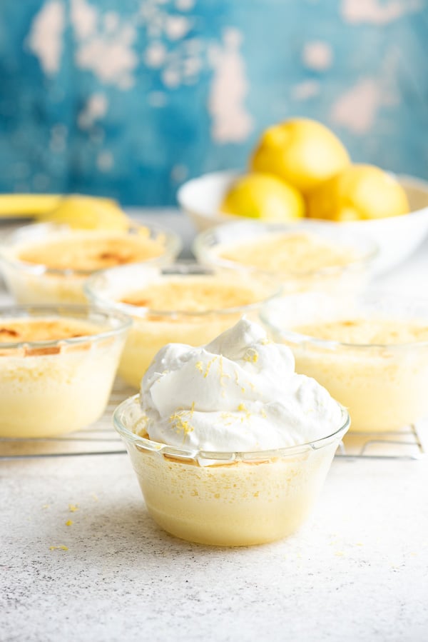 Lemon Baked Custard with Sponge Cake Top with whipped cream in glass custard cups