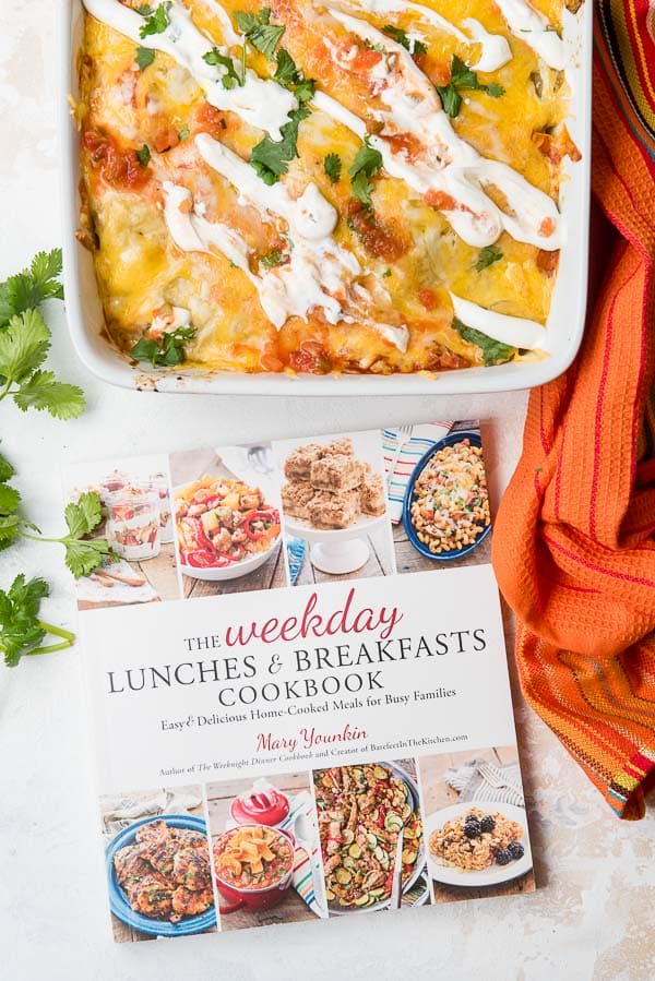 Weekday Lunches and Breakfasts Cookbook and Christmas Breakfast Enchilada Casserole in a white baking dish