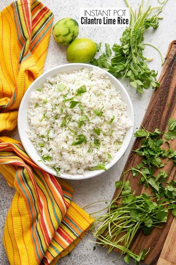 Instant Pot Cilantro Lime Rice in a large white bowl with fresh cilantro and zested limes