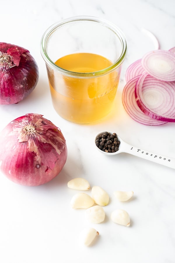 ingredients for quick pickled red onion recipe with a canning jar