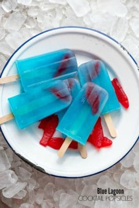 Blue Lagoon Cocktail popsicles on a white plate on ice