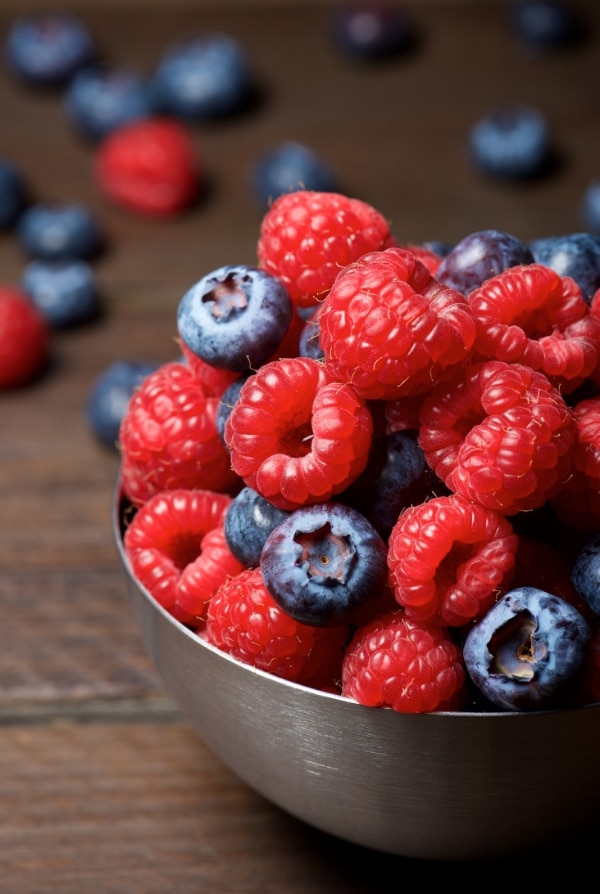 raspberries and blueberries in a bowl