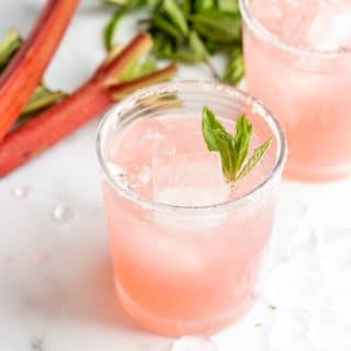 Refreshing, pink Rhubarb Pie Cocktail (a rhubarb vodka cocktail) with rhubarb in the background