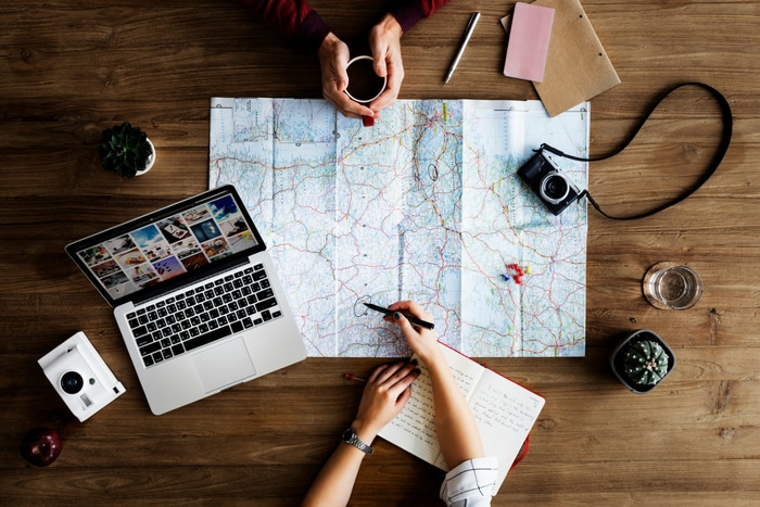 trip planning with map and laptop