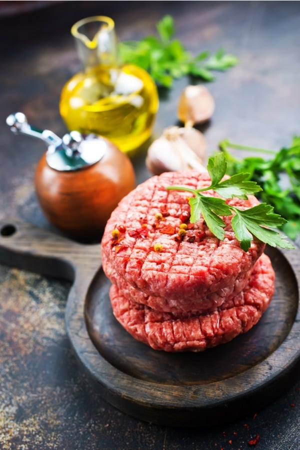 Stack of ground beef patties with spices