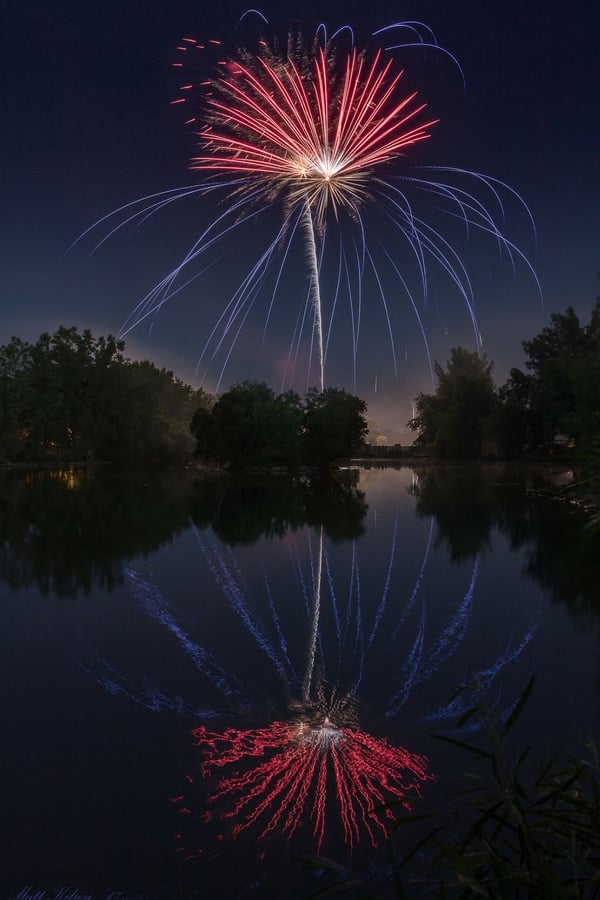 Fireworks reflecting in a lake
