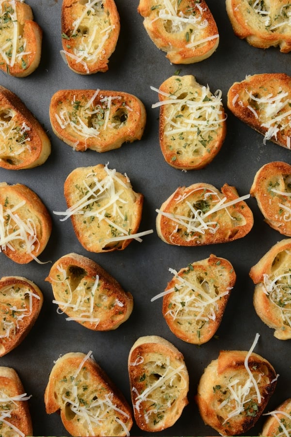 slices of garlic bread on sheet pan