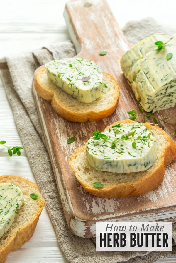 slices of bread with herb butter on cutting board