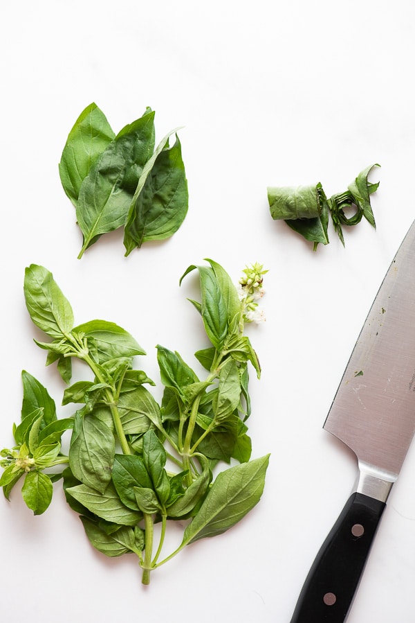 Fresh basil and slicing Basil with knife