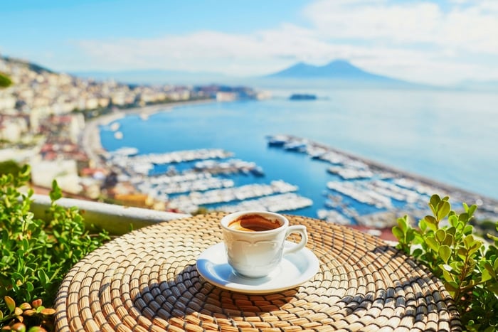 coffee on table overlooking a harbor