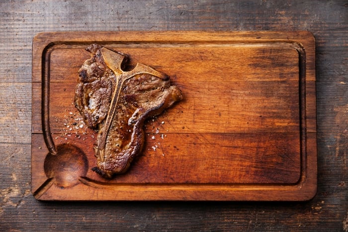 T-Bone steak on wood cutting board