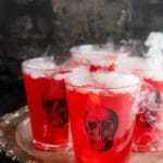 Glasses of punch with dry ice on tray (title image)