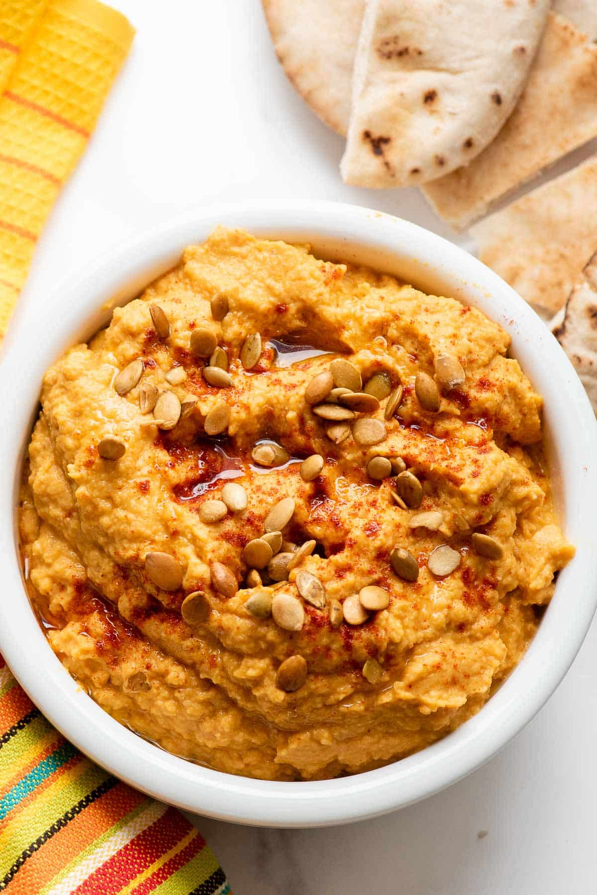 spicy pumpkin hummus with pita bread close up.