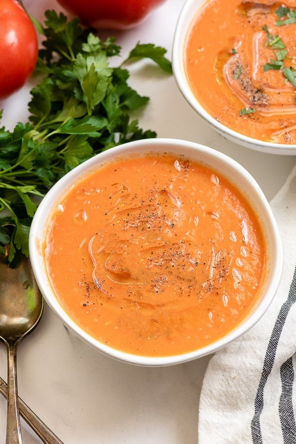 homemade tomato soup in white bowl 
