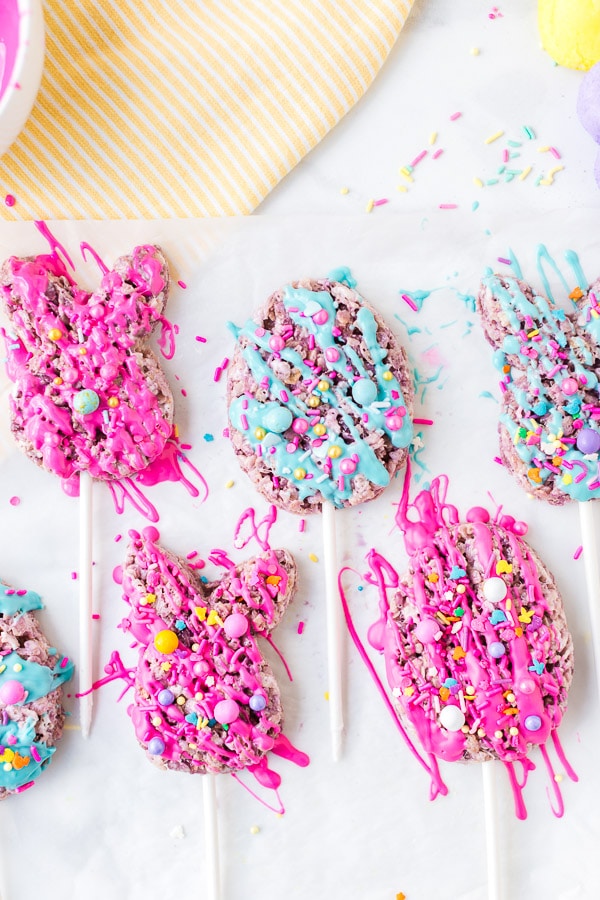 cookie cutter with rice krispie treat on stick drizzled with melted chocolate decorated 