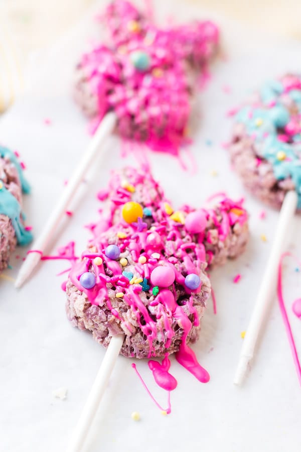 cookie cutter with rice krispie treat on stick drizzled with melted chocolate decorated close up 