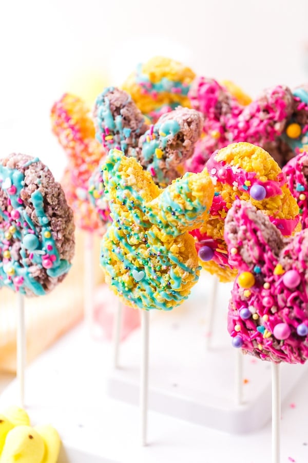 cookie cutter with rice krispie treat on stick drizzled with melted chocolate decorated close up multiple 2 