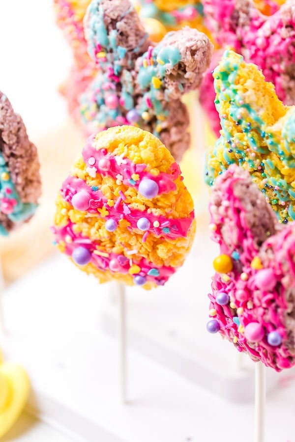 multiple colorful decorated rice krispie treats on a stick for Easter