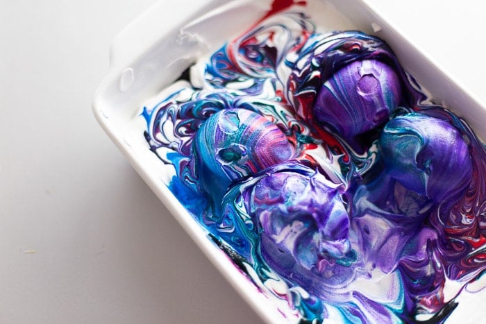 dying easter eggs in colored cool whip purple