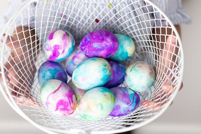 dying easter eggs with shaving cream in white wire basket 