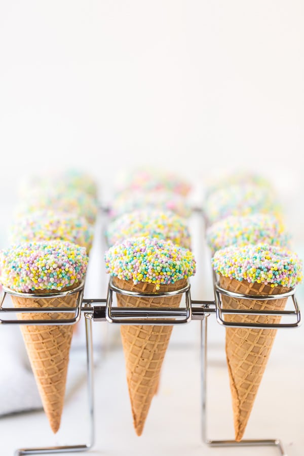 ice cream cone cupcakes with sprinkles in cone rack