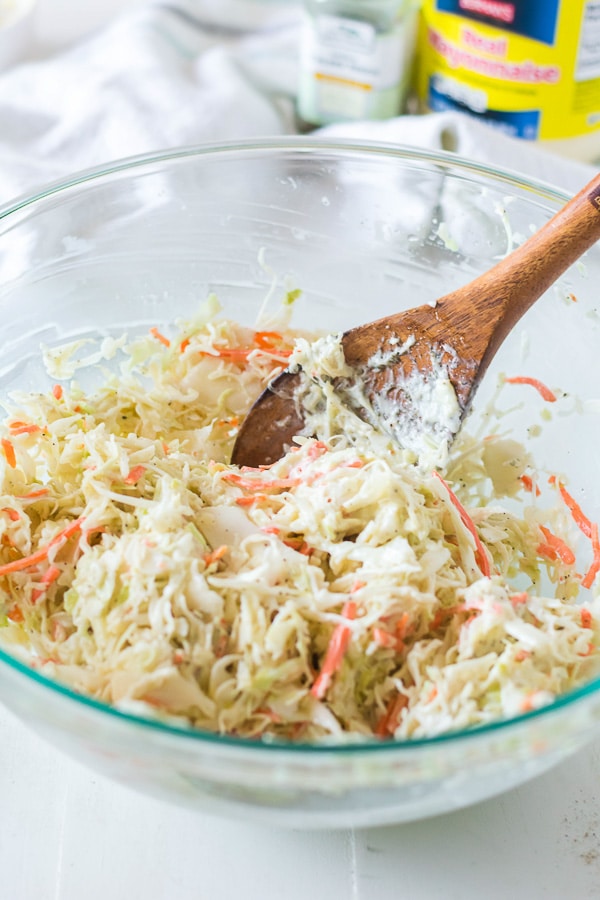 mixing coleslaw in bowl