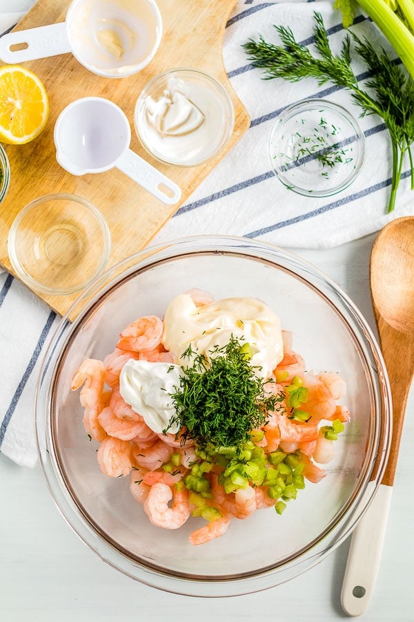 shrimp in bowl with ingredients for shrimp salad