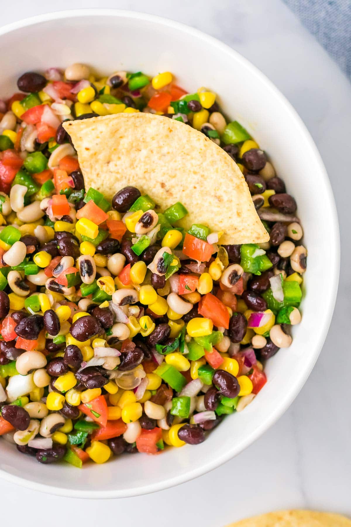 cowboy caviar in bowl with tortilla chip