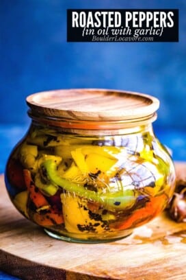 colorful roasted peppers in jar with oil and garlic.