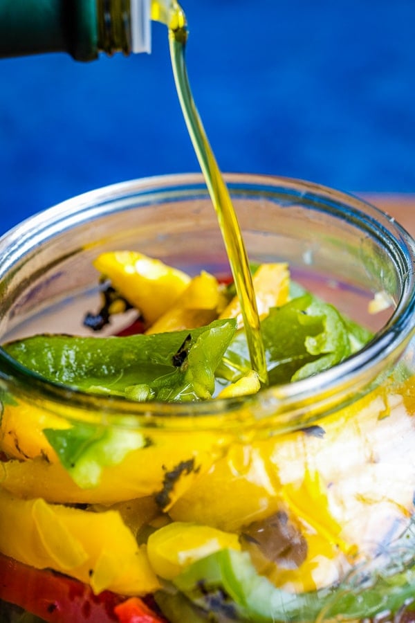 roasted peppers in jar oil pouring