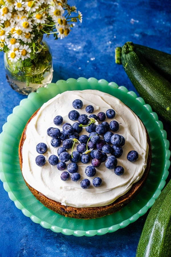 zucchini cake with blueberries on green plate 