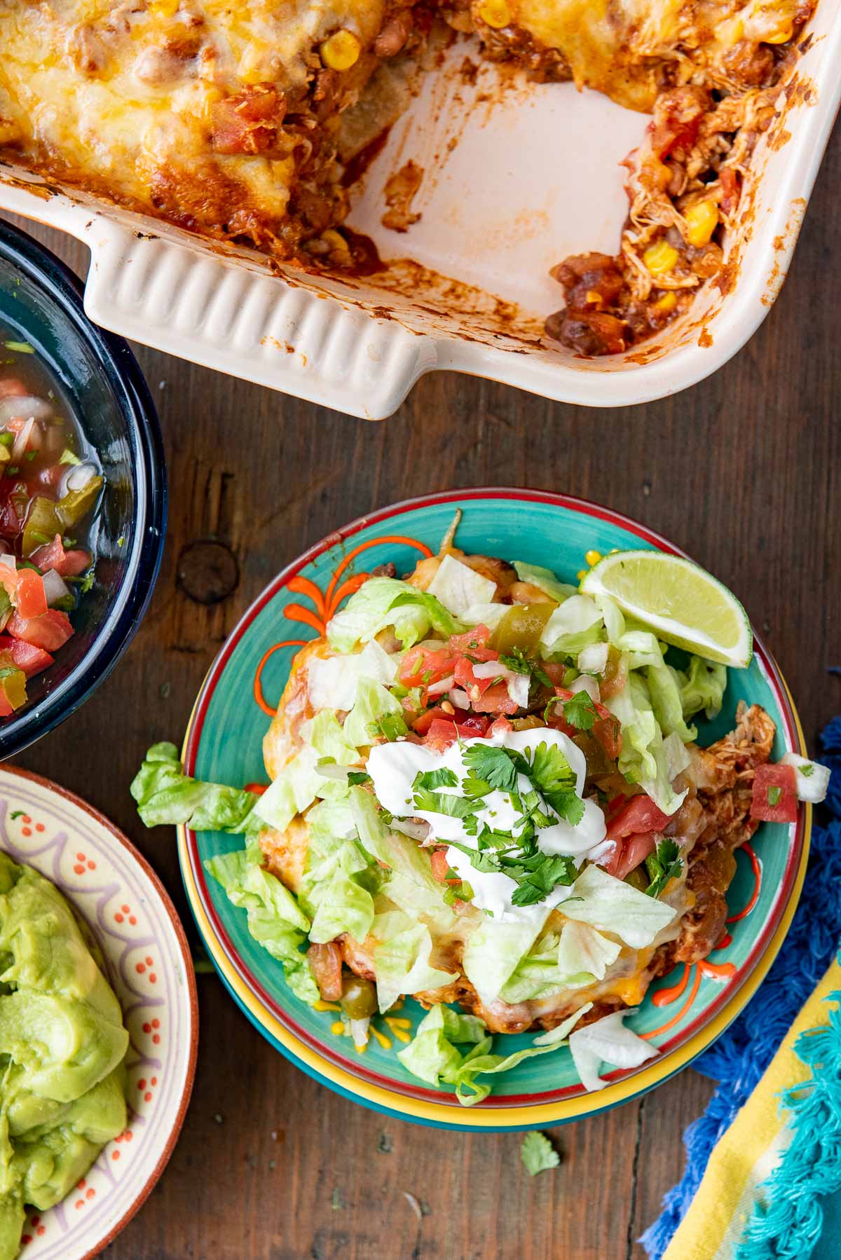 mexican chicken casserole on plate with toppings