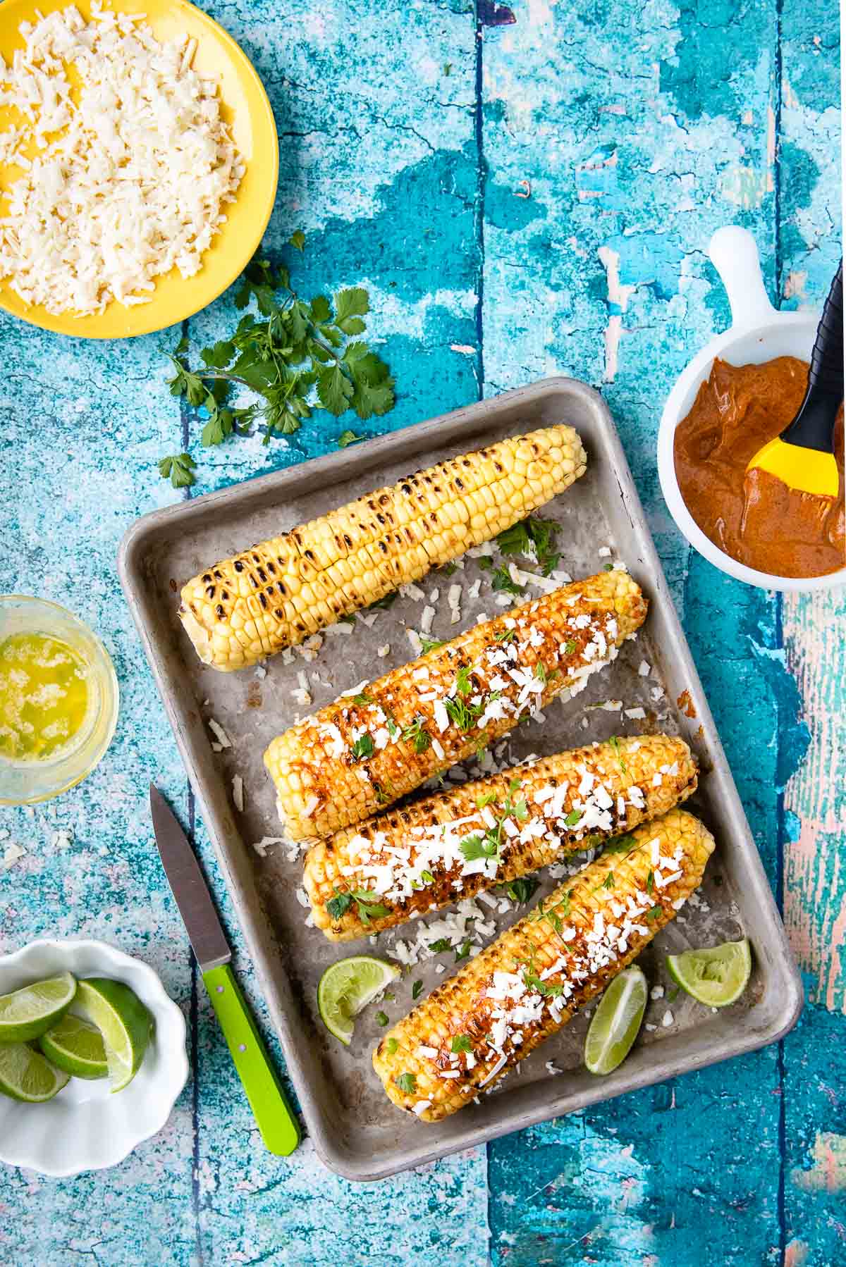 elote in baking sheet with ingredients 