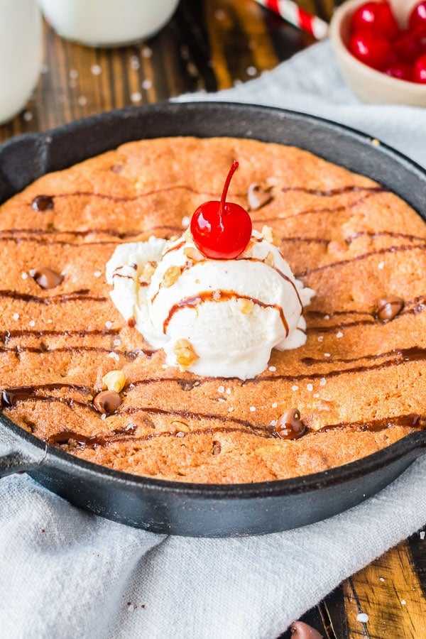 pizookie cookie in skillet topped with ice cream scoop