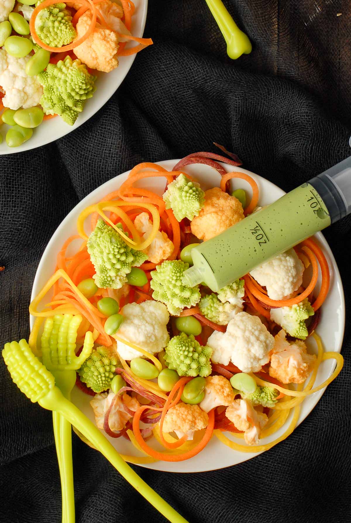 halloween salad in bowl with dressing syringe