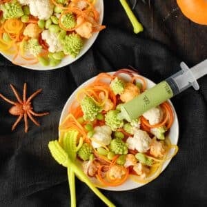 halloween salad in bowls with dressing syringes