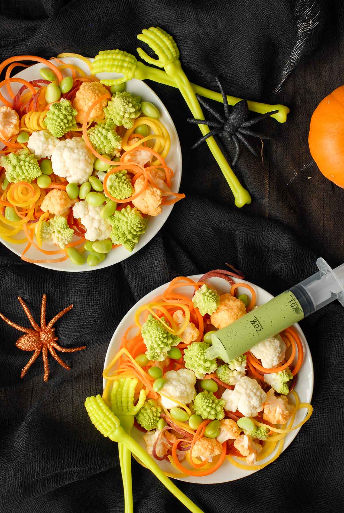 halloween salad in bowls with dressing syringes overhead