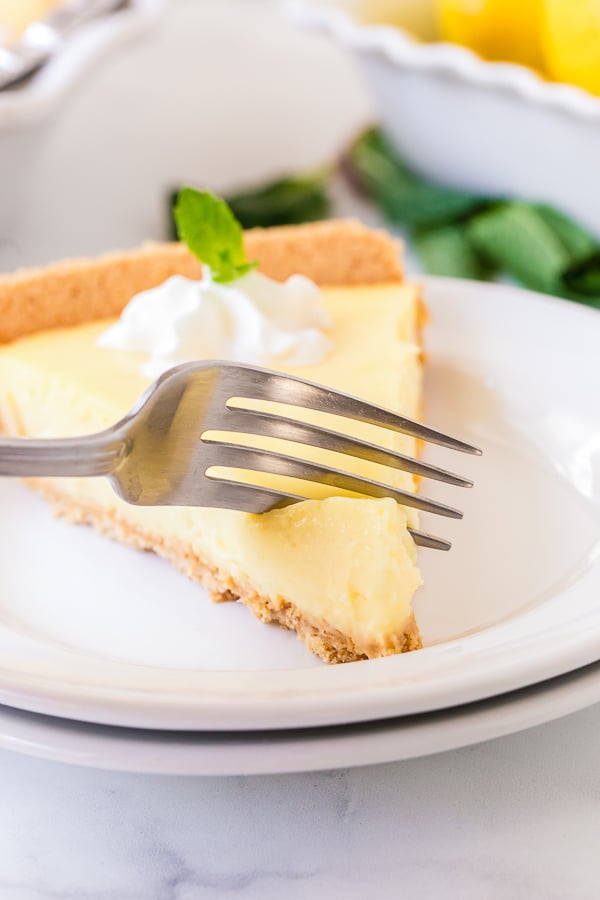 lemon pie slice on plate with fork