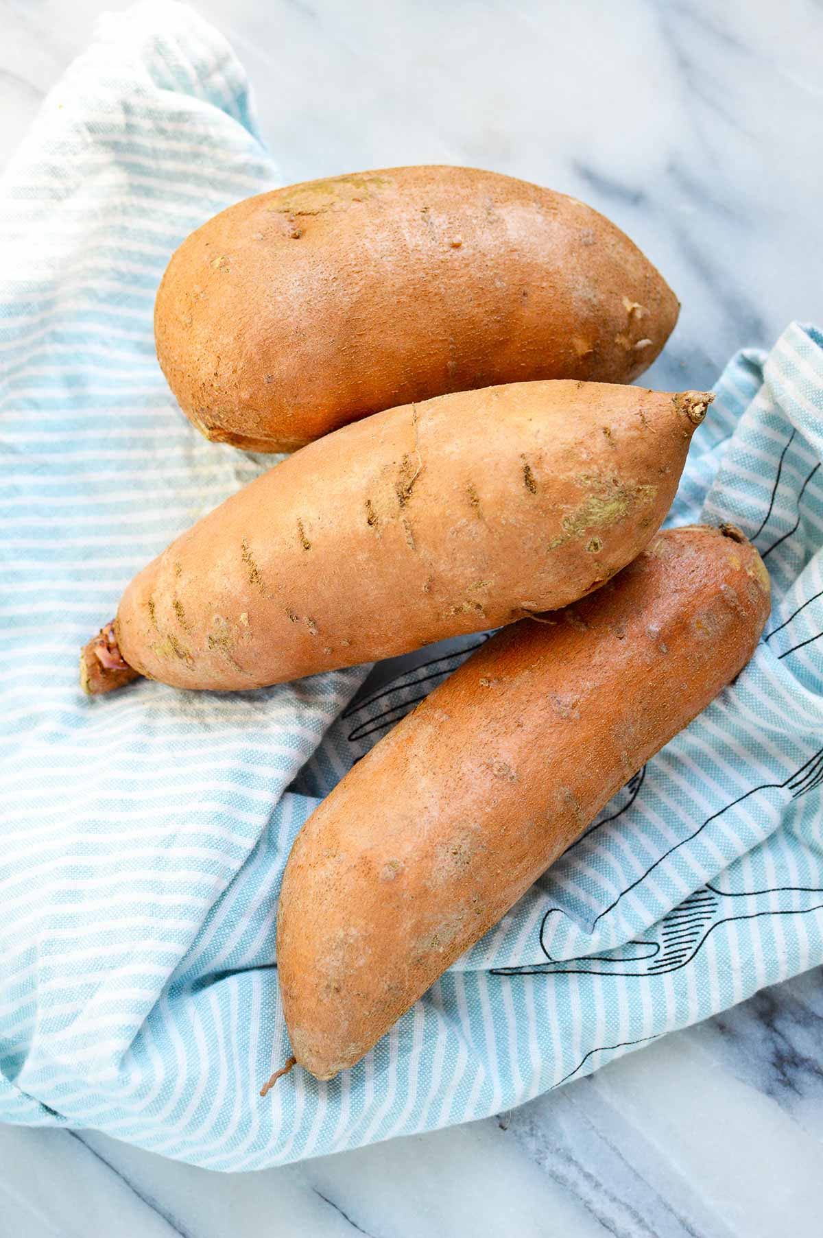 sweet potatoes on blue cloth.