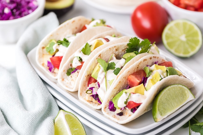 fish tacos on a platter with ingredients