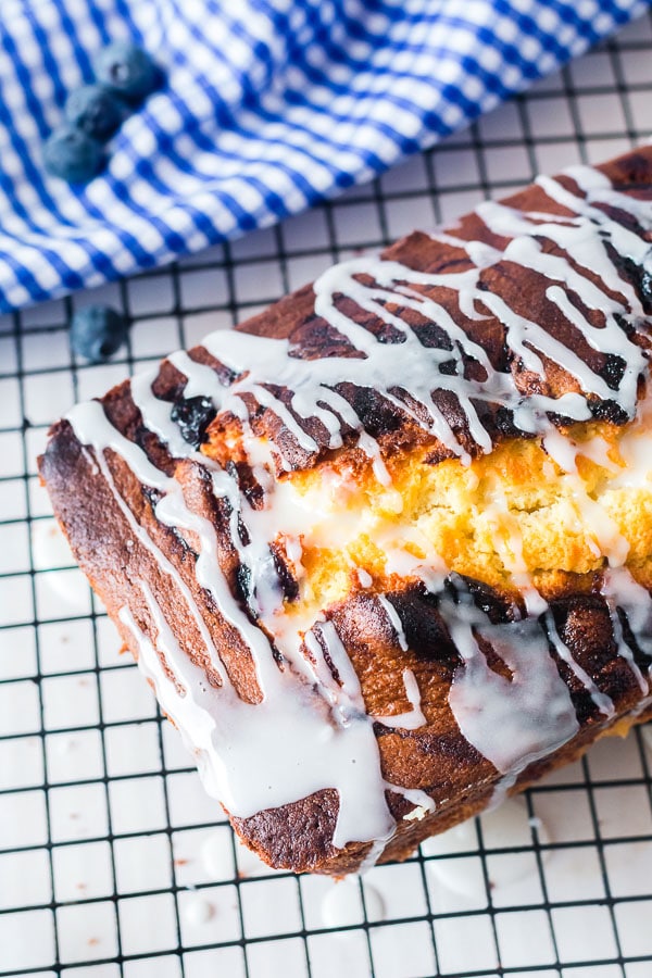 glazed top of lemon pound cake on cooling rack